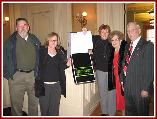 Puppy Mill Project volunteers delivering over 25,000 signatures on our petition in support of AB-250. Joyce is the lady in the red dress.